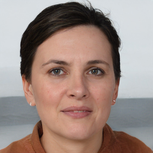 Joyful white adult female with short  brown hair and brown eyes