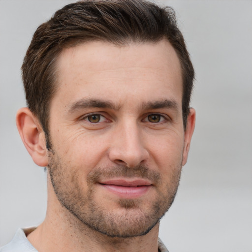 Joyful white young-adult male with short  brown hair and brown eyes