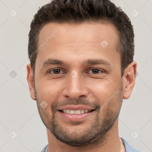 Joyful white young-adult male with short  brown hair and brown eyes