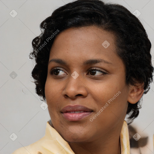 Joyful black young-adult female with medium  black hair and brown eyes