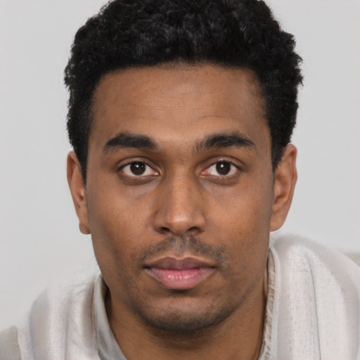 Neutral black young-adult male with short  black hair and brown eyes