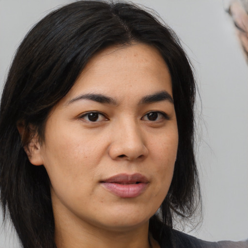 Joyful asian young-adult female with medium  brown hair and brown eyes