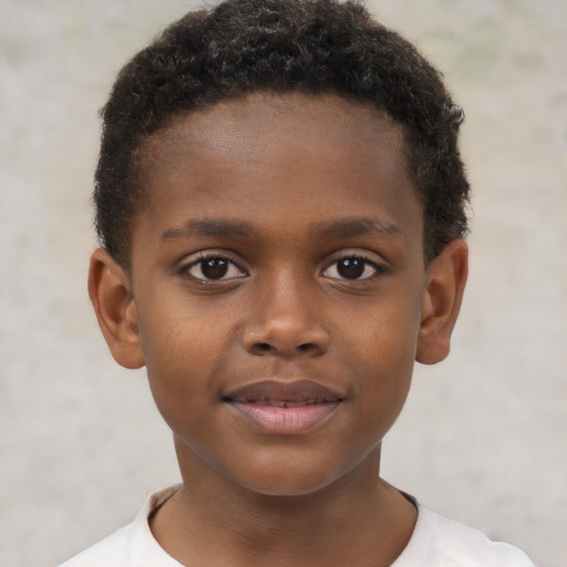 Joyful black child male with short  brown hair and brown eyes