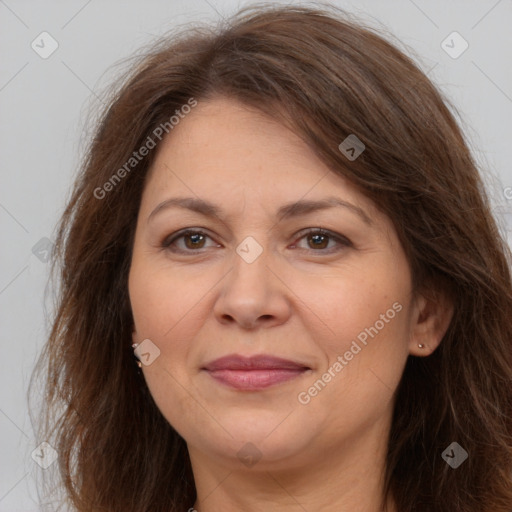 Joyful white adult female with long  brown hair and brown eyes