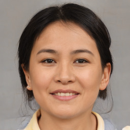 Joyful asian young-adult female with medium  brown hair and brown eyes