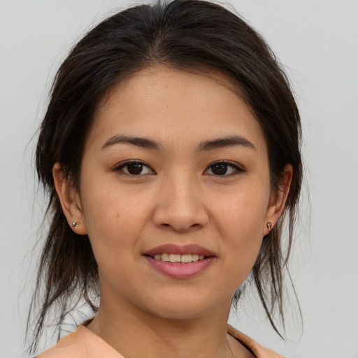 Joyful asian young-adult female with medium  brown hair and brown eyes