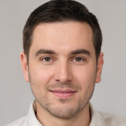 Joyful white young-adult male with short  brown hair and brown eyes