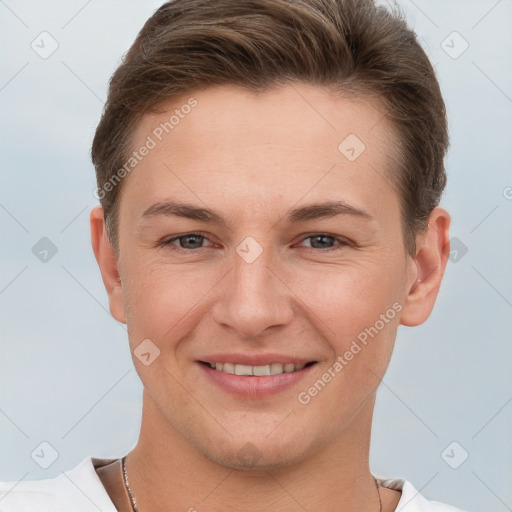 Joyful white young-adult male with short  brown hair and grey eyes