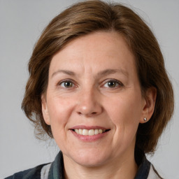 Joyful white adult female with medium  brown hair and grey eyes