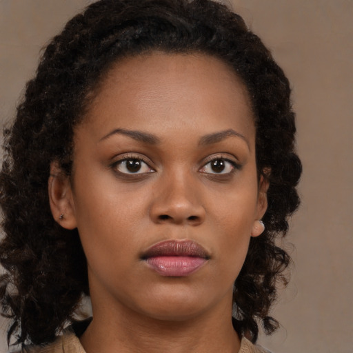 Neutral black young-adult female with medium  brown hair and brown eyes
