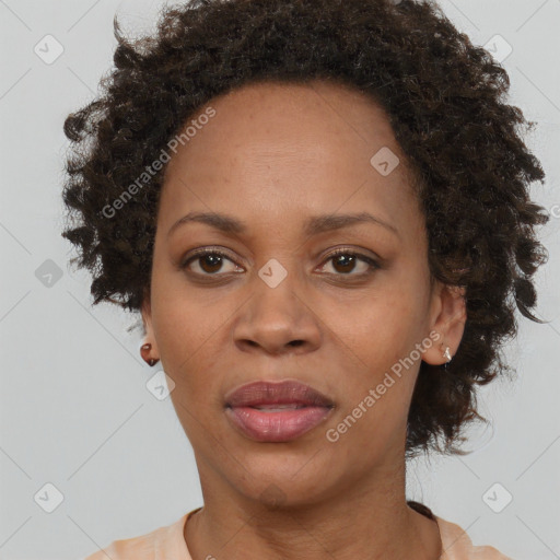 Joyful black adult female with short  brown hair and brown eyes