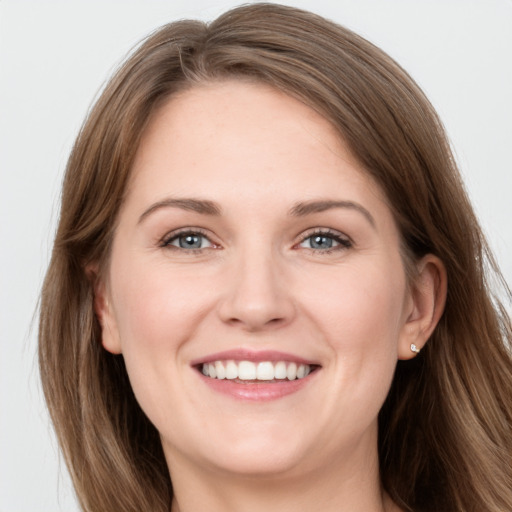 Joyful white young-adult female with long  brown hair and grey eyes