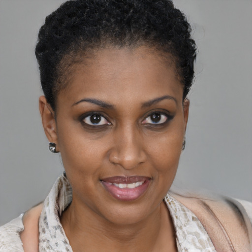 Joyful black young-adult female with short  brown hair and brown eyes