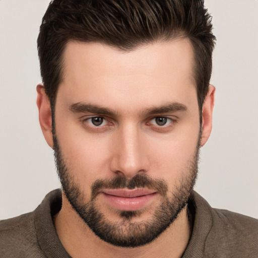 Joyful white young-adult male with short  brown hair and brown eyes