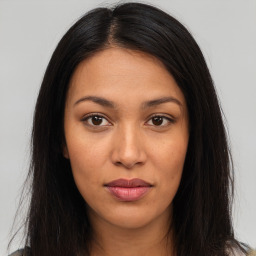 Joyful latino young-adult female with long  brown hair and brown eyes