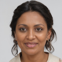 Joyful black young-adult female with medium  brown hair and brown eyes