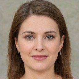 Joyful white young-adult female with medium  brown hair and green eyes