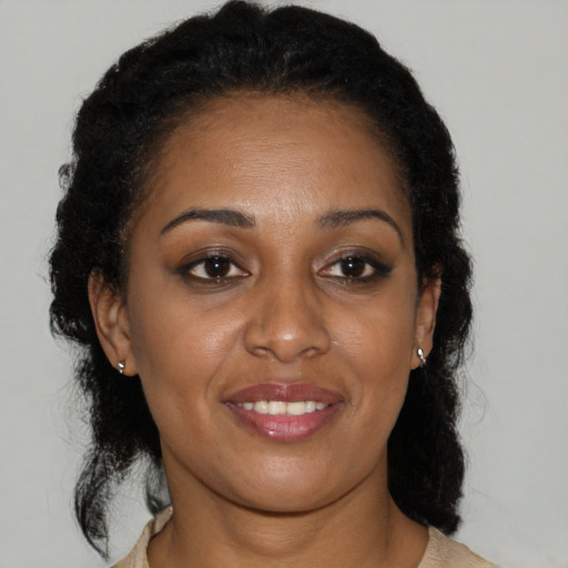 Joyful black young-adult female with medium  brown hair and brown eyes