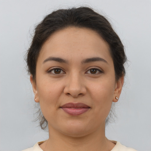 Joyful latino young-adult female with short  brown hair and brown eyes