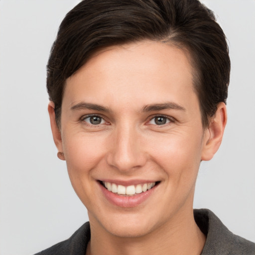 Joyful white young-adult female with short  brown hair and brown eyes