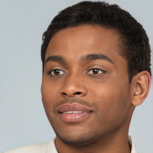 Joyful black young-adult male with short  brown hair and brown eyes