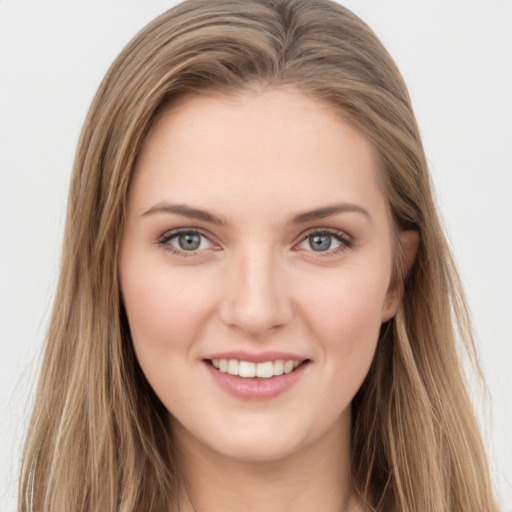 Joyful white young-adult female with long  brown hair and green eyes