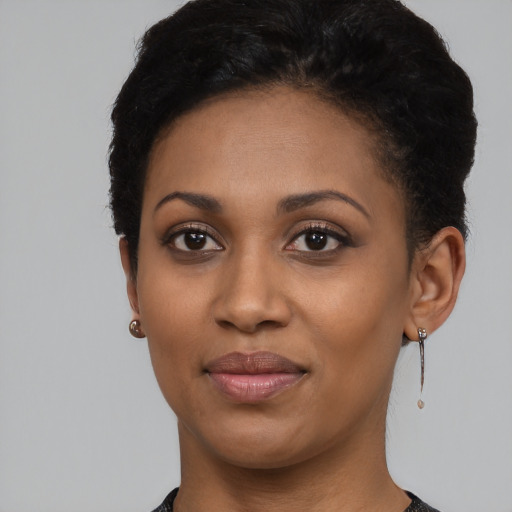 Joyful black young-adult female with short  black hair and brown eyes