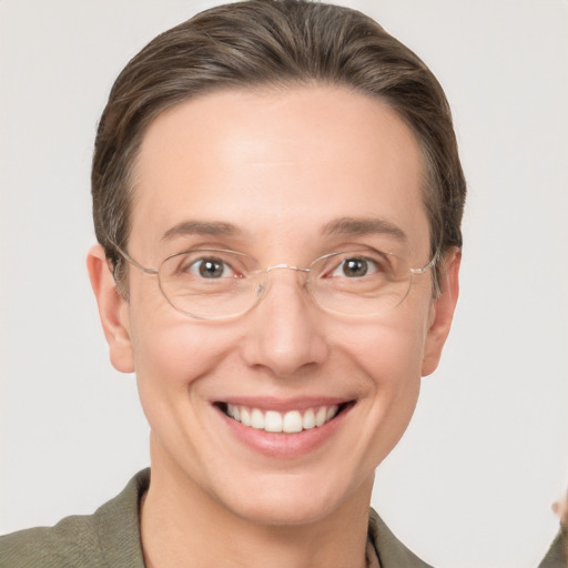 Joyful white adult female with medium  brown hair and grey eyes