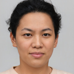 Joyful asian young-adult female with short  brown hair and brown eyes