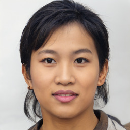 Joyful asian young-adult female with medium  black hair and brown eyes