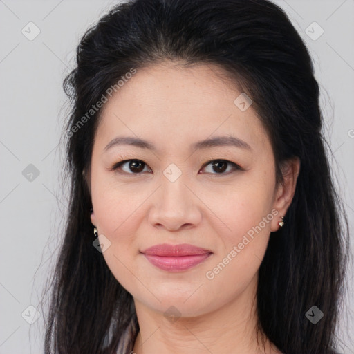 Joyful asian young-adult female with long  brown hair and brown eyes