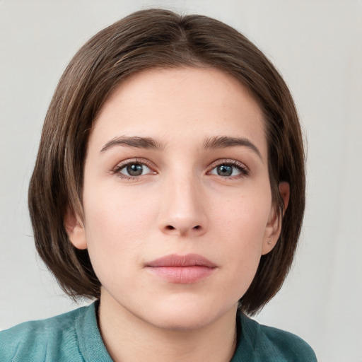 Neutral white young-adult female with medium  brown hair and grey eyes