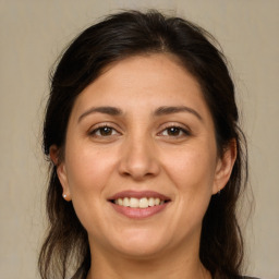 Joyful white adult female with long  brown hair and brown eyes