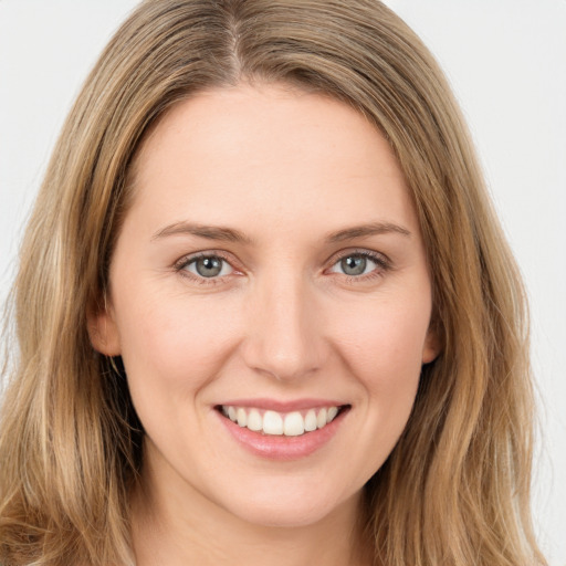 Joyful white young-adult female with long  brown hair and green eyes