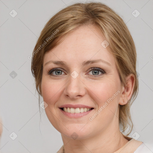 Joyful white young-adult female with medium  brown hair and blue eyes