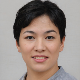 Joyful asian young-adult female with short  black hair and brown eyes