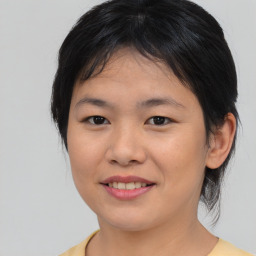 Joyful asian young-adult female with medium  brown hair and brown eyes