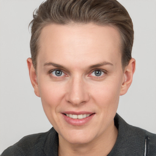 Joyful white adult female with short  brown hair and grey eyes