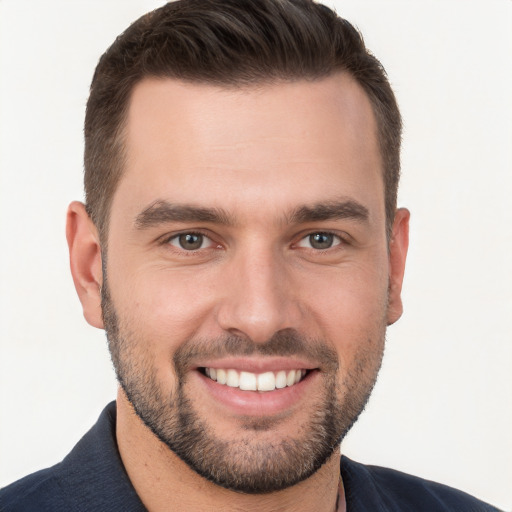 Joyful white young-adult male with short  brown hair and brown eyes