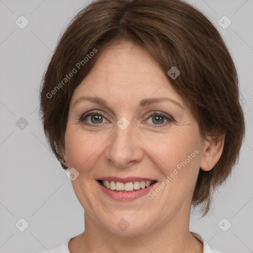 Joyful white adult female with medium  brown hair and grey eyes