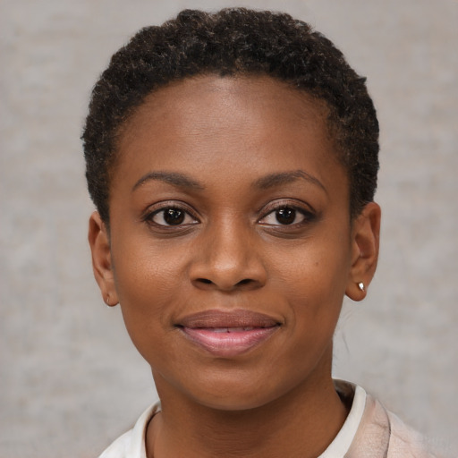 Joyful black young-adult female with short  brown hair and brown eyes