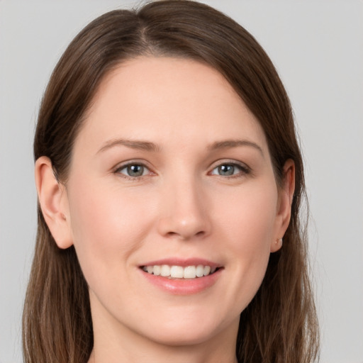 Joyful white young-adult female with long  brown hair and grey eyes