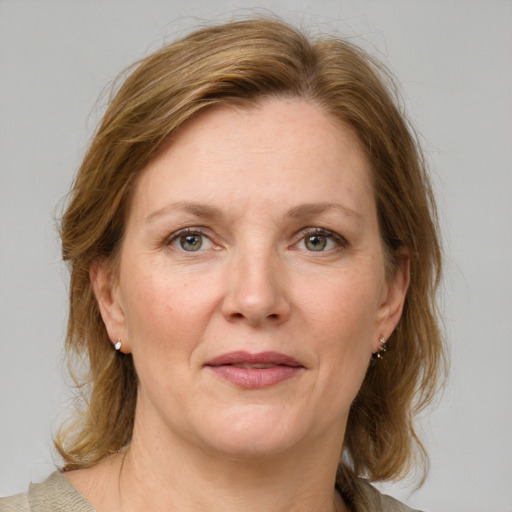 Joyful white adult female with medium  brown hair and grey eyes