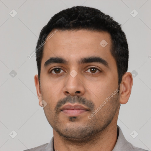 Neutral latino young-adult male with short  black hair and brown eyes