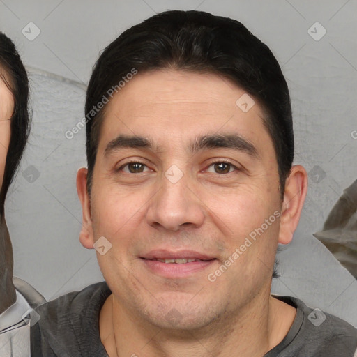 Joyful white adult male with short  brown hair and brown eyes