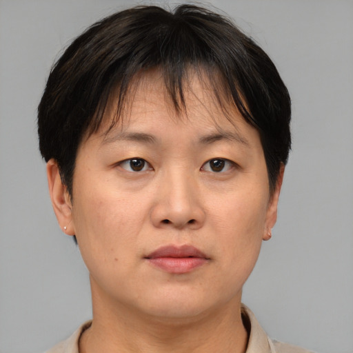 Neutral asian adult female with short  brown hair and brown eyes