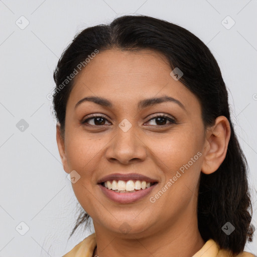 Joyful latino young-adult female with medium  brown hair and brown eyes