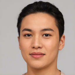 Joyful asian young-adult male with short  brown hair and brown eyes