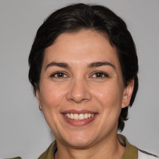 Joyful white adult female with medium  brown hair and brown eyes