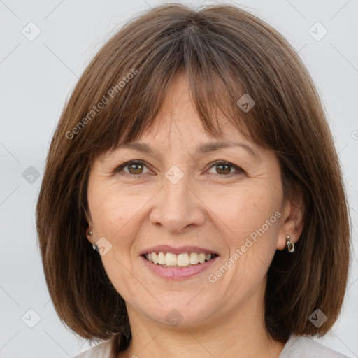 Joyful white adult female with medium  brown hair and brown eyes